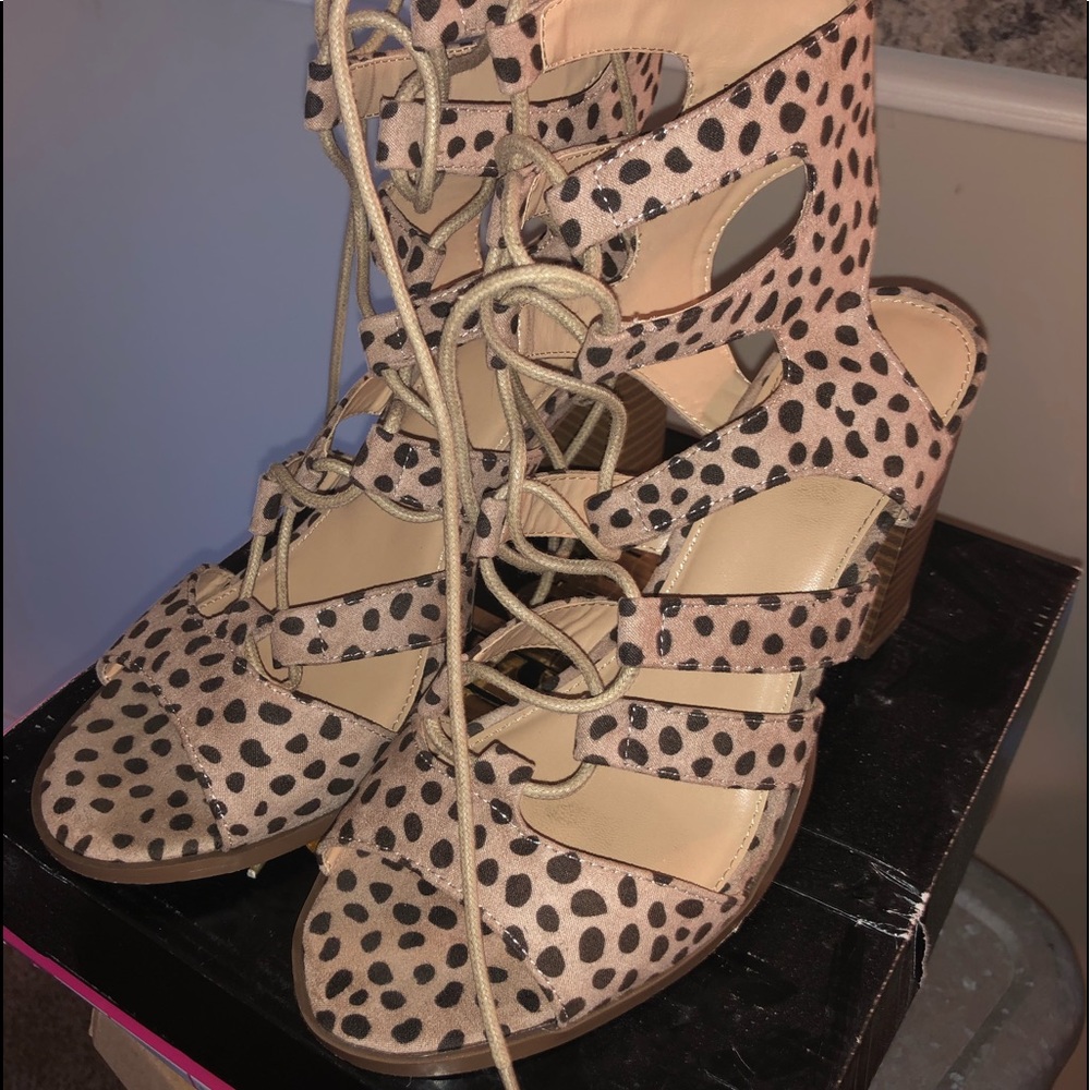 Brown print sandal with heel. Ties up ankle.